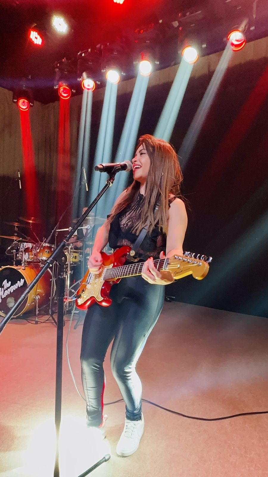 Musicista da The Flavours tocando guitarra no palco